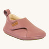 Froddo barefoot walker baby shoe in dark pink. A natural leather shoe with a pull tab on the back for easy fitting, a velcro fastener and a grippy sole