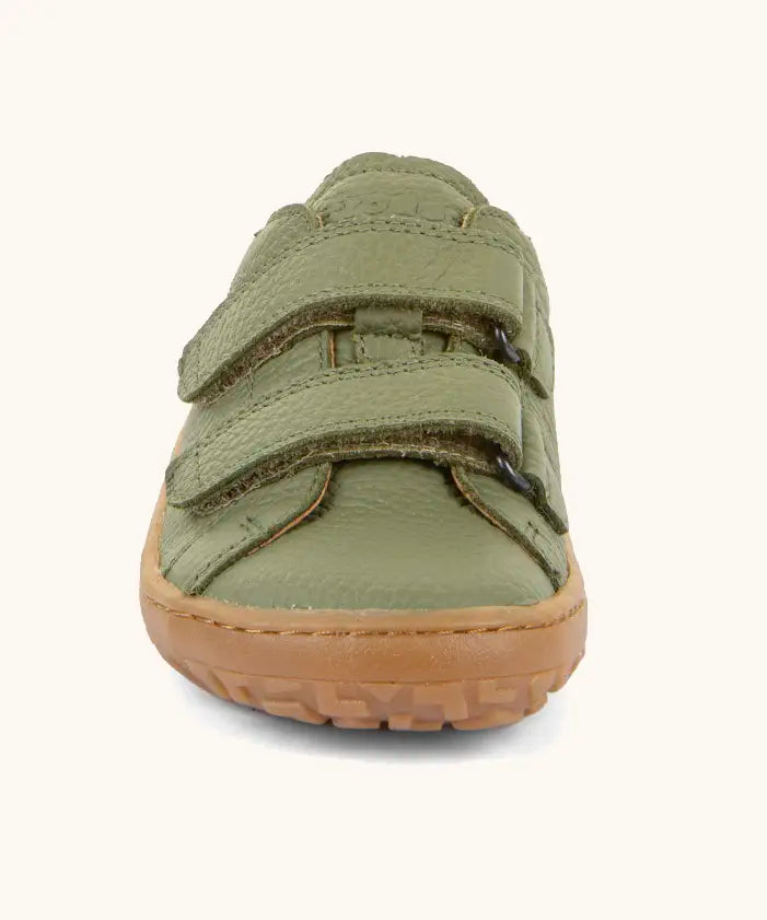 Front of the Froddo barefoot base children's shoe in green showing the 2 velcro fasteners and the brown grippy sole detail