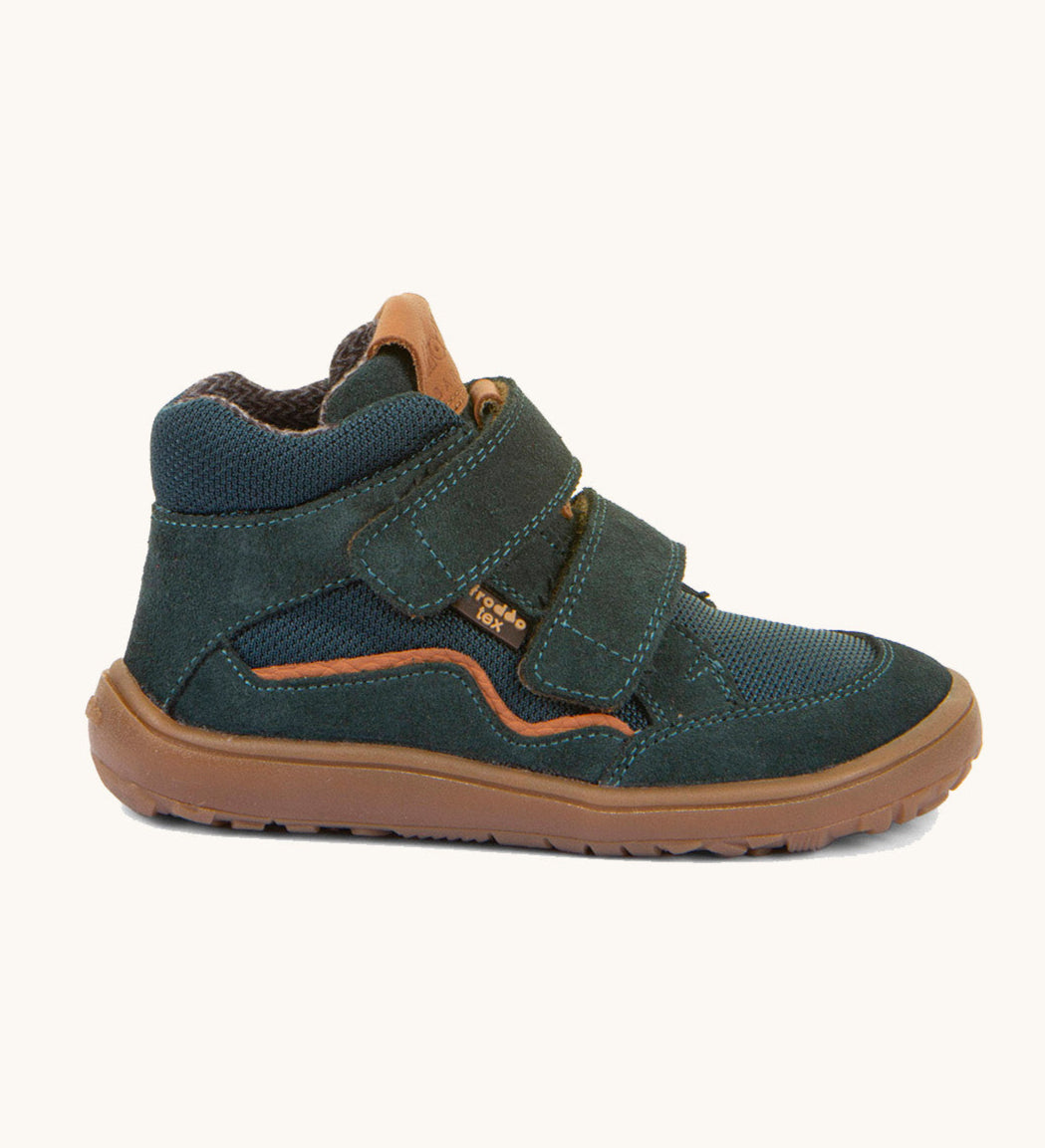 A side image of the Froddo barefoot Tex Autumn children's shoe in petroleum available at Babipur. A dark turquoise shoe showing 2 velcro fasteners on the front for a secure fit, padded ankle and a brown grippy sole.