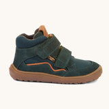 A side image of the Froddo barefoot Tex Autumn children's shoe in petroleum available at Babipur. A dark turquoise shoe showing 2 velcro fasteners on the front for a secure fit, padded ankle and a brown grippy sole.