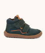 A side image of the Froddo barefoot Tex Autumn children's shoe in petroleum available at Babipur. A dark turquoise shoe showing 2 velcro fasteners on the front for a secure fit, padded ankle and a brown grippy sole.