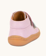 A view of the back of the Froddo first step shoes in pink available at Babipur. A soft ankle high natural leather shoe in light pink with 2 velcro straps on the front in dark pink and light blue. Features a light brown rubber grippy sole and a padded ankle support.