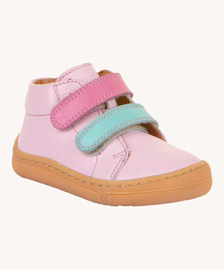 Froddo first step shoes in pink available at Babipur. A soft ankle high natural leather shoe in light pink with 2 velcro straps on the front in dark pink and light blue. Features a light brown rubber grippy sole and a padded ankle support