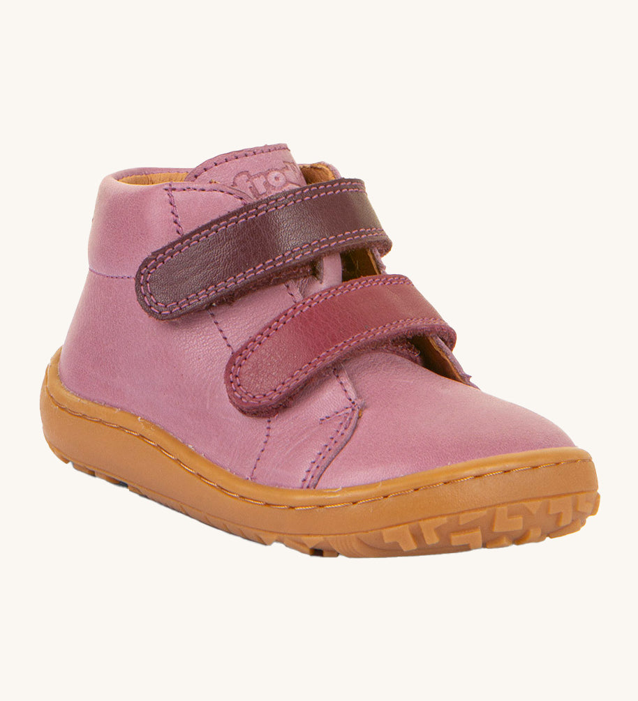 Froddo barefoot first step baby shoe in pink. A natural leather shoe with a 2 darker pink velcro fastener for a secure fit and a light brown grippy sole