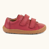 Side of Froddo barefoot base children's shoe in red showing the 2 velcro fasteners looped through and the brown grippy sole