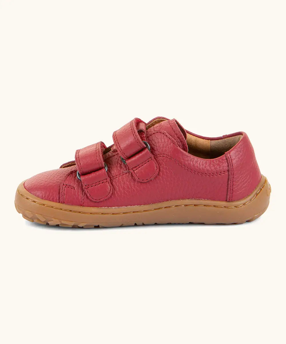 Side of Froddo barefoot base children's shoe in red showing the 2 velcro fasteners looped through the eyelets