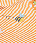 Close up of the Frugi kids lifeboat stripe veg t-shirt. Showing the bee applique with grey wings on orange and white stripe organic cotton fabric