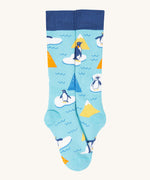 A close up of the Frugi light blue penguin brilliant boot sock showing the penguin print and dark blue cuff detail on organic cotton fabric
