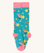 A close up of the rainbow Frugi brilliant boot sock showing the yellow star print and pink toe and heel detail on light blue organic cotton fabric