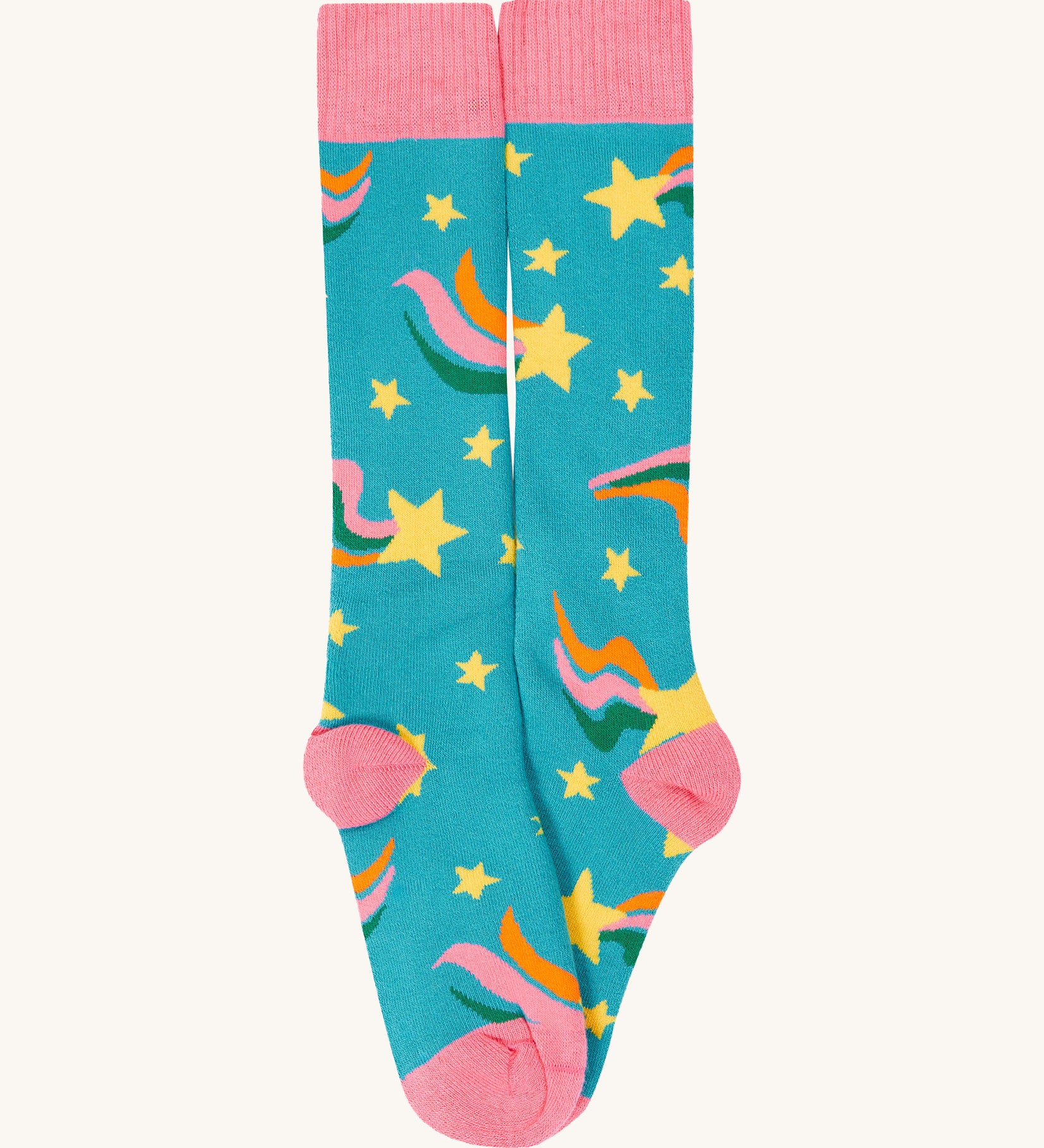 A close up of the rainbow Frugi brilliant boot sock showing the yellow star print and pink toe and heel detail on light blue organic cotton fabric