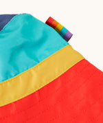 Close up of side of the Frugi swim hat showing the rainbow stripe label on the side.