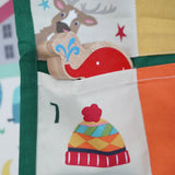 Close up of a Babipur elephant Lnaka Kade figure placed into one of the pockets on the Frugi forest festive fun organic cotton advent calendar.