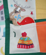 Close up of a Babipur elephant Lnaka Kade figure placed into one of the pockets on the Frugi forest festive fun organic cotton advent calendar.