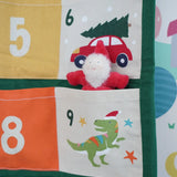 Close up of a Grimm's red bearded dwarf figure placed into one of the pockets on the Frugi forest festive fun organic cotton advent calendar.
