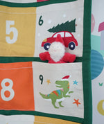Close up of a Grimm's red bearded dwarf figure placed into one of the pockets on the Frugi forest festive fun organic cotton advent calendar.