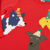 Close up of the front of the Frugi organic cotton adventure circular long sleeve top scarlet red with three dogs wearing party hats on the front. 