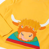 Close up of the Frugi adventure circular cotton top in bumblebee yellow with a Highland cow applique on the front.