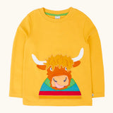 Frugi adventure circular cotton top in bumblebee yellow with a Highland cow applique on the front.