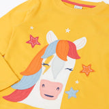 Close up of the Frugi adventure circular organic cotton long sleeve top in bumblebee yellow with a white horse applique with a rainbow mane on the front surrounded by stars.