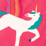 Close up of the unicorn applique and embroidered rainbow detail on the Frugi agatha organic cotton pink corduroy pinafore child's dress.