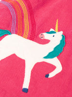 Close up of the unicorn applique and embroidered rainbow detail on the Frugi agatha organic cotton pink corduroy pinafore child's dress.