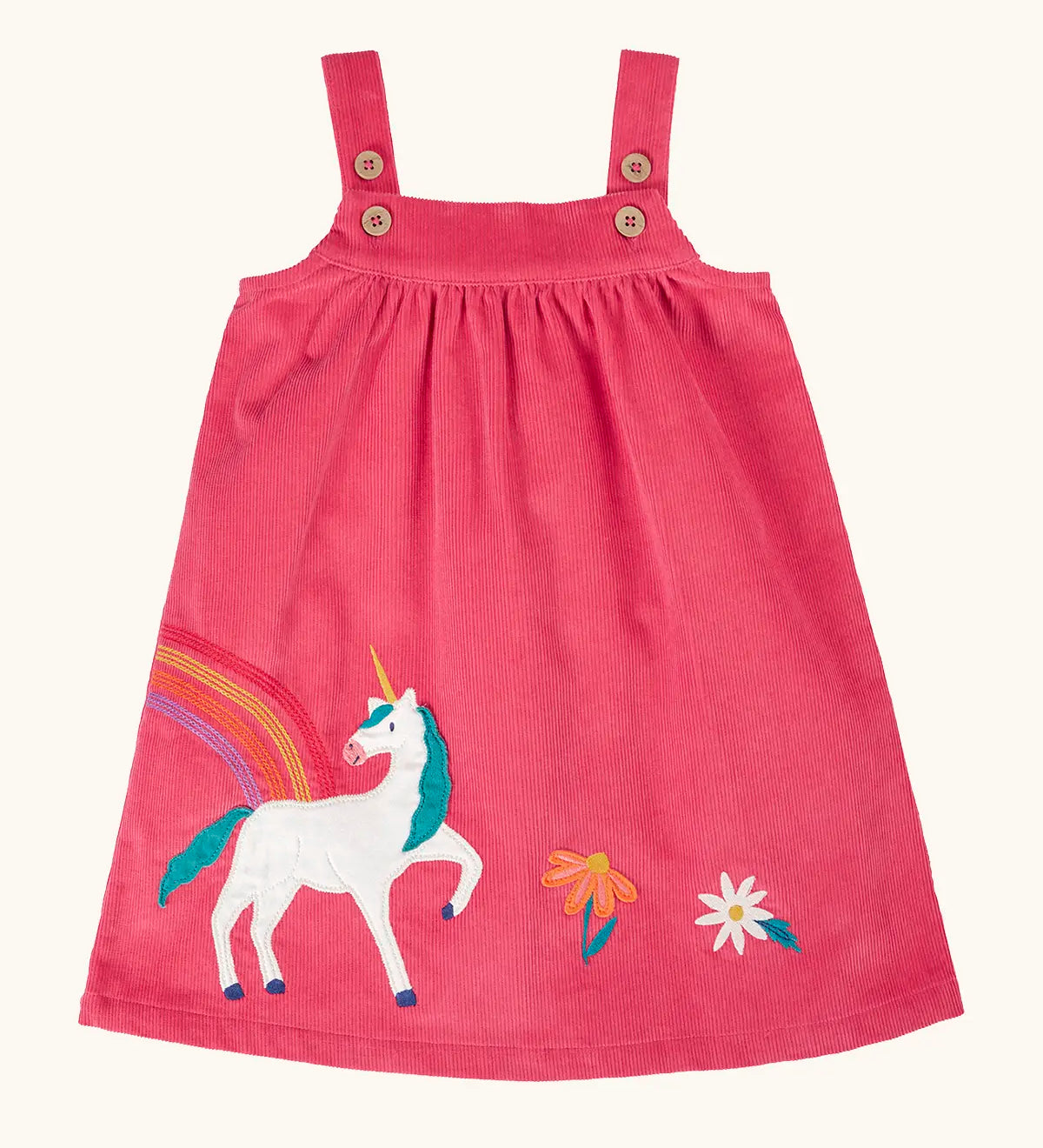 Frugi agatha organic cotton pink corduroy pinafore child's dress with unicorn applique and rainbow and flower details along the hemline.