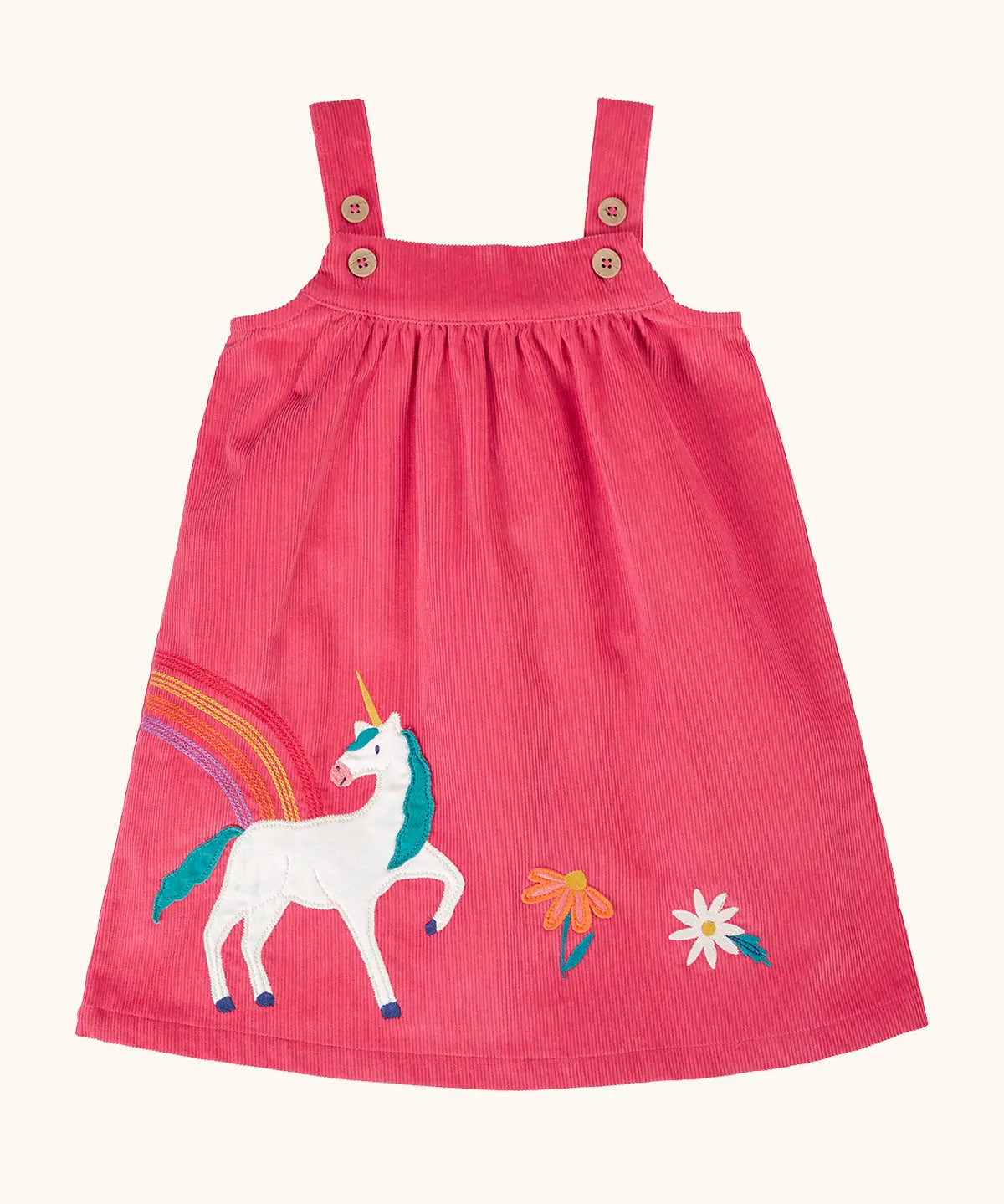 Frugi agatha organic cotton pink corduroy pinafore child's dress with unicorn applique and rainbow and flower details along the hemline.