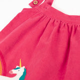 Close up of the two position button closure on the straps of the Frugi agatha organic cotton pink corduroy pinafore child's dress with unicorn applique.