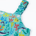 A close up of Frugi Alani Midi Dress' straps, featuring a Sea Life print which includes different sea animals and colourful seaweed and coral.