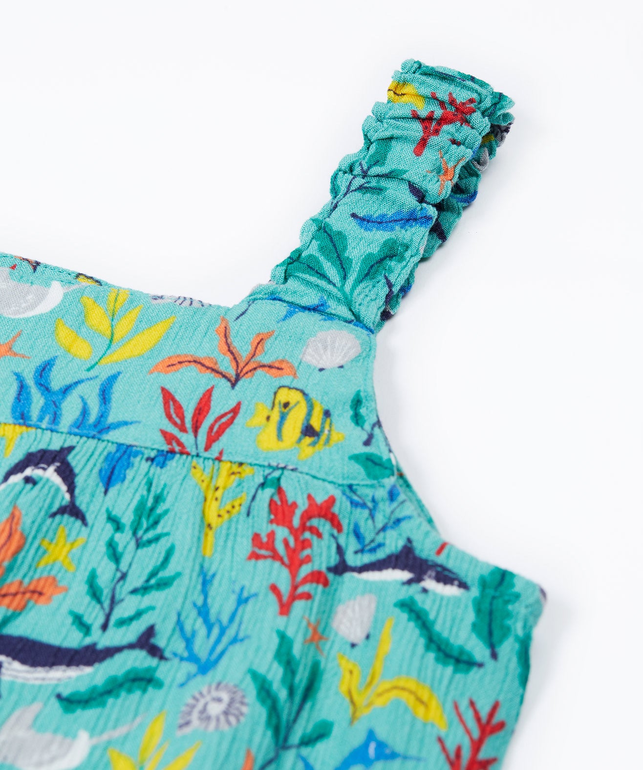 A close up of Frugi Alani Midi Dress' straps, featuring a Sea Life print which includes different sea animals and colourful seaweed and coral.