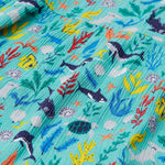 A close up of Frugi Alani Midi Dress, featuring a Sea Life print which includes different sea animals and colourful seaweed and coral on a mint background.