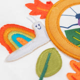 A close up of the snail embroidered snail applique Frugi organic cotton Alfie interactive long sleeved top.