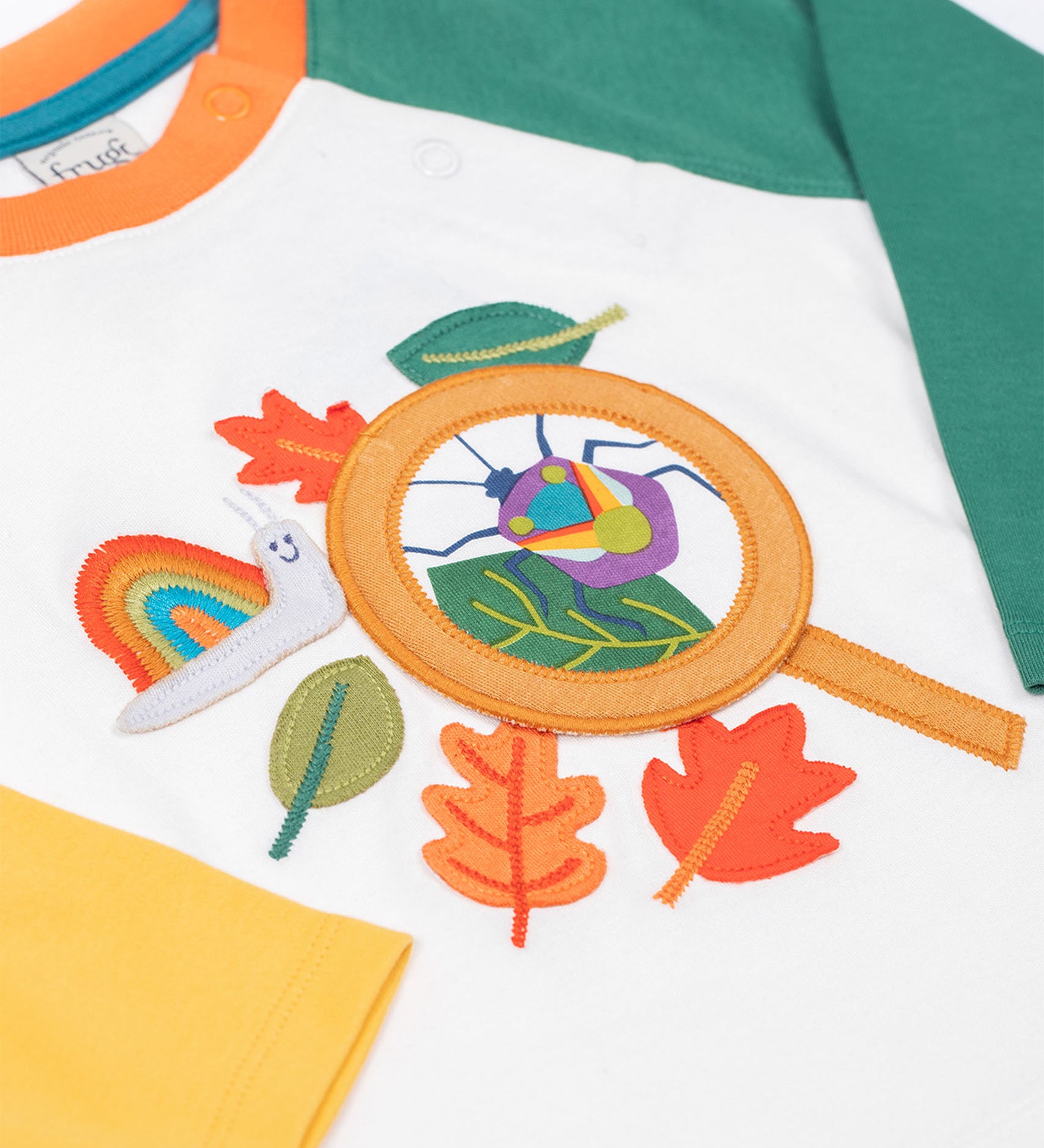 Frugi organic cotton Alfie interactive long sleeved top. One sleeve is green one is yellow. 