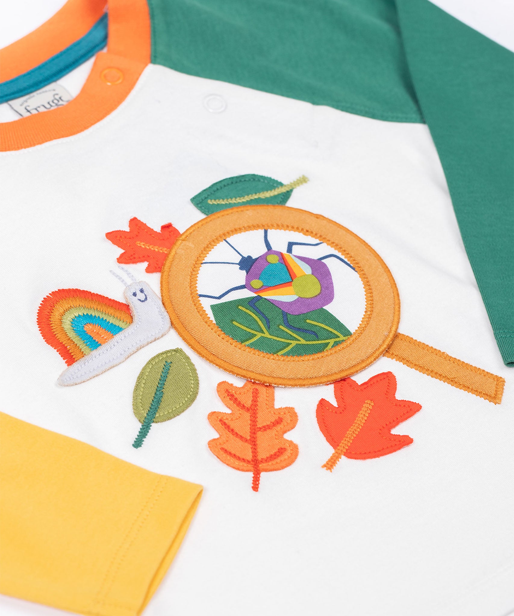 Frugi organic cotton Alfie interactive long sleeved top. One sleeve is green one is yellow. 
