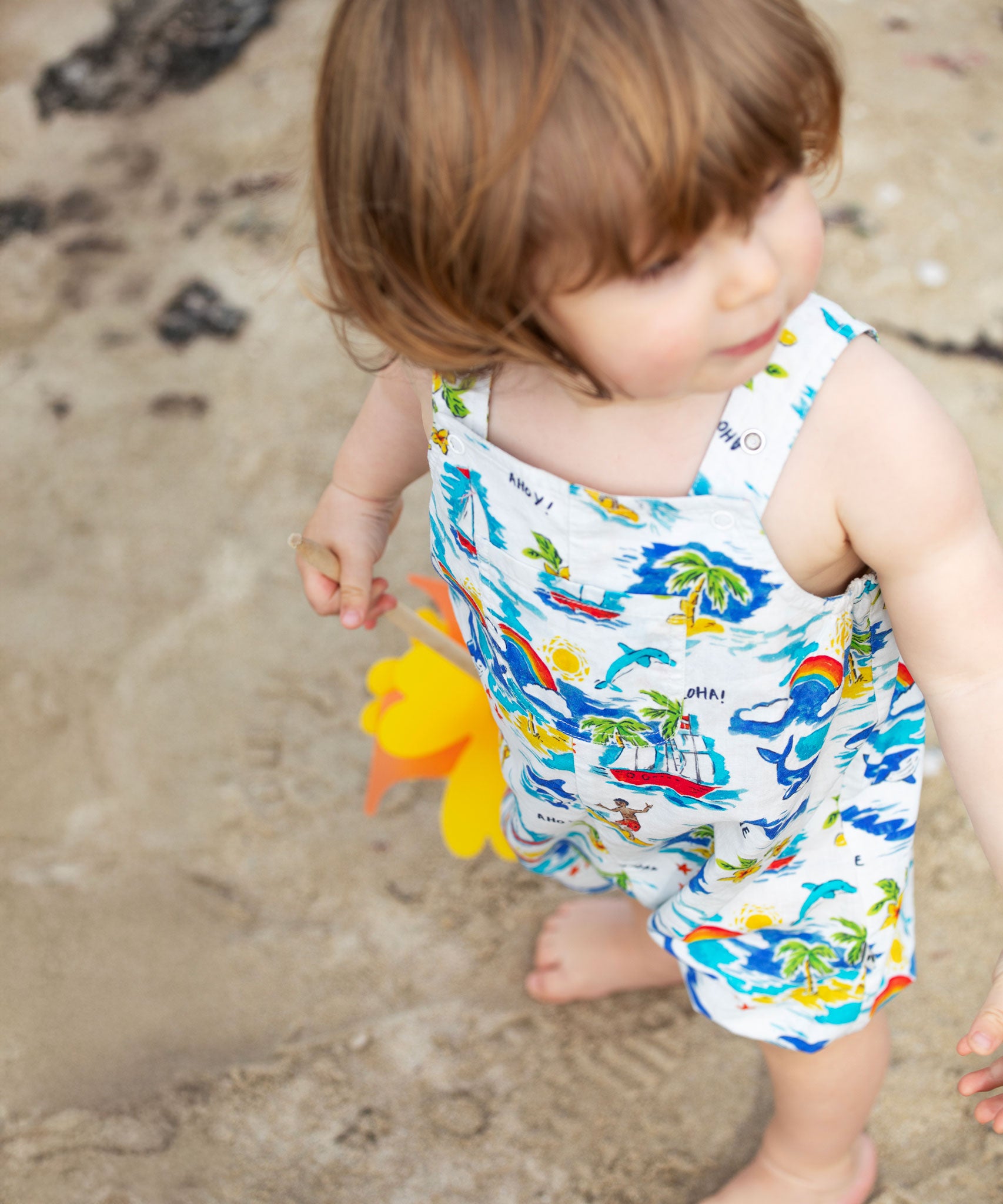 A child wearing the Frugi Aloha Baxter Dungaree.