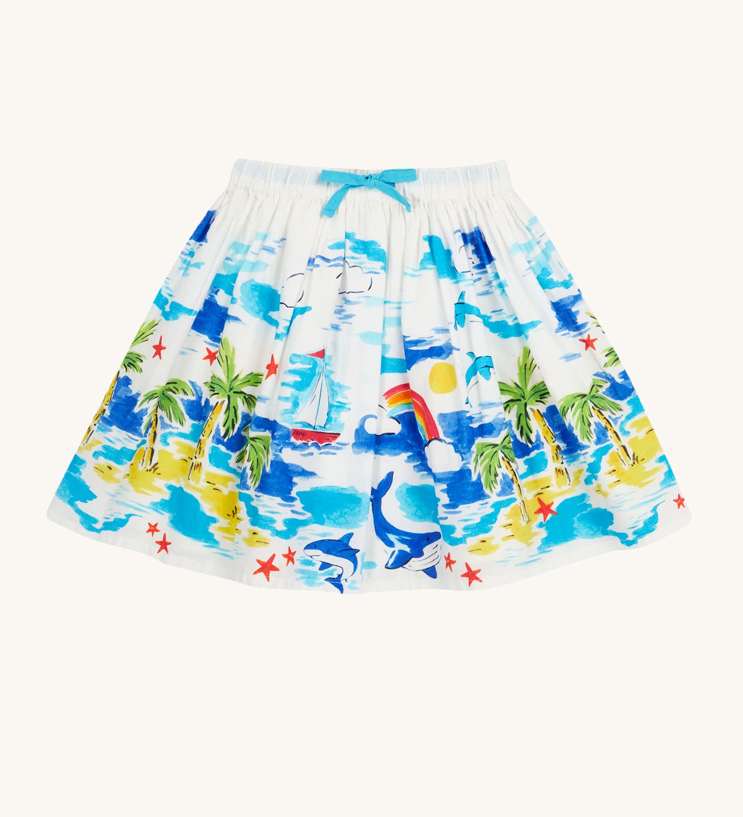 Frugi Twirly Dream Skirt laid flat, featuring a Aloha Scene, which includes a tropical print with sailing ships, dolphins, rainbows, palm trees and beach motifs on a white background, with a blue drawstring.