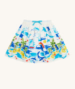 Frugi Twirly Dream Skirt laid flat, featuring a Aloha Scene, which includes a tropical print with sailing ships, dolphins, rainbows, palm trees and beach motifs on a white background, with a blue drawstring.