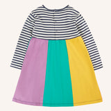 Back of the Frugi amelia rainbow dress navy breton stripe top and wide rainbow stripe skirt. The dress has a poppered closure on the back.