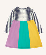 Back of the Frugi amelia rainbow dress navy breton stripe top and wide rainbow stripe skirt. The dress has a poppered closure on the back.