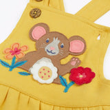 Close up of the mouse and flowers applique on the front of the Frugi Ania bumblebee yellow organic cotton pinafore dress.