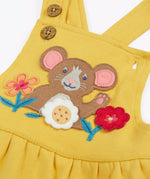 Close up of the mouse and flowers applique on the front of the Frugi Ania bumblebee yellow organic cotton pinafore dress.