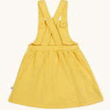Frugi Ania pineafore dress in a warm yellow with adjustable cross straps, made from organic cotton.