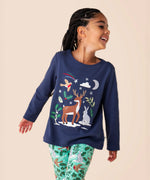 A close up of a child wearing the Frugi navy reindeer Anna top available at Babipur showing the reindeer and woodland animal appliques