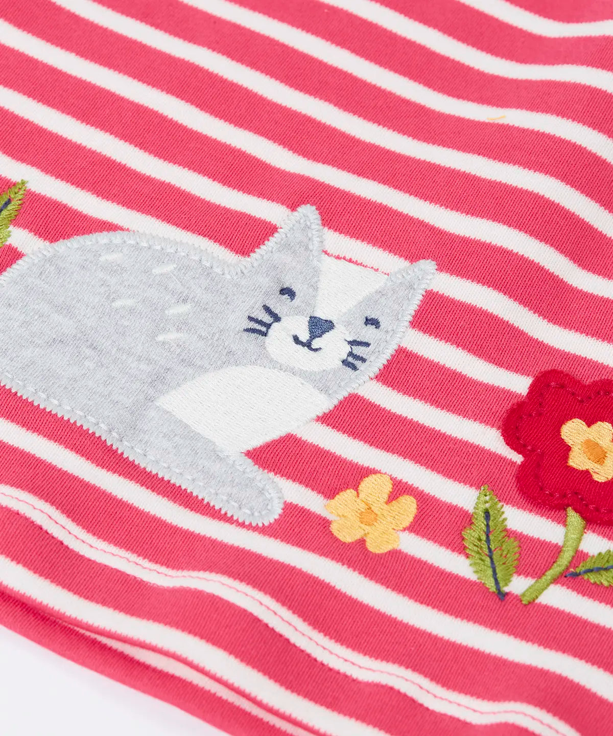 Close up of the grey cat applique on the Frugi organic cotton archer dress in rhubarb pink Breton stripes. 