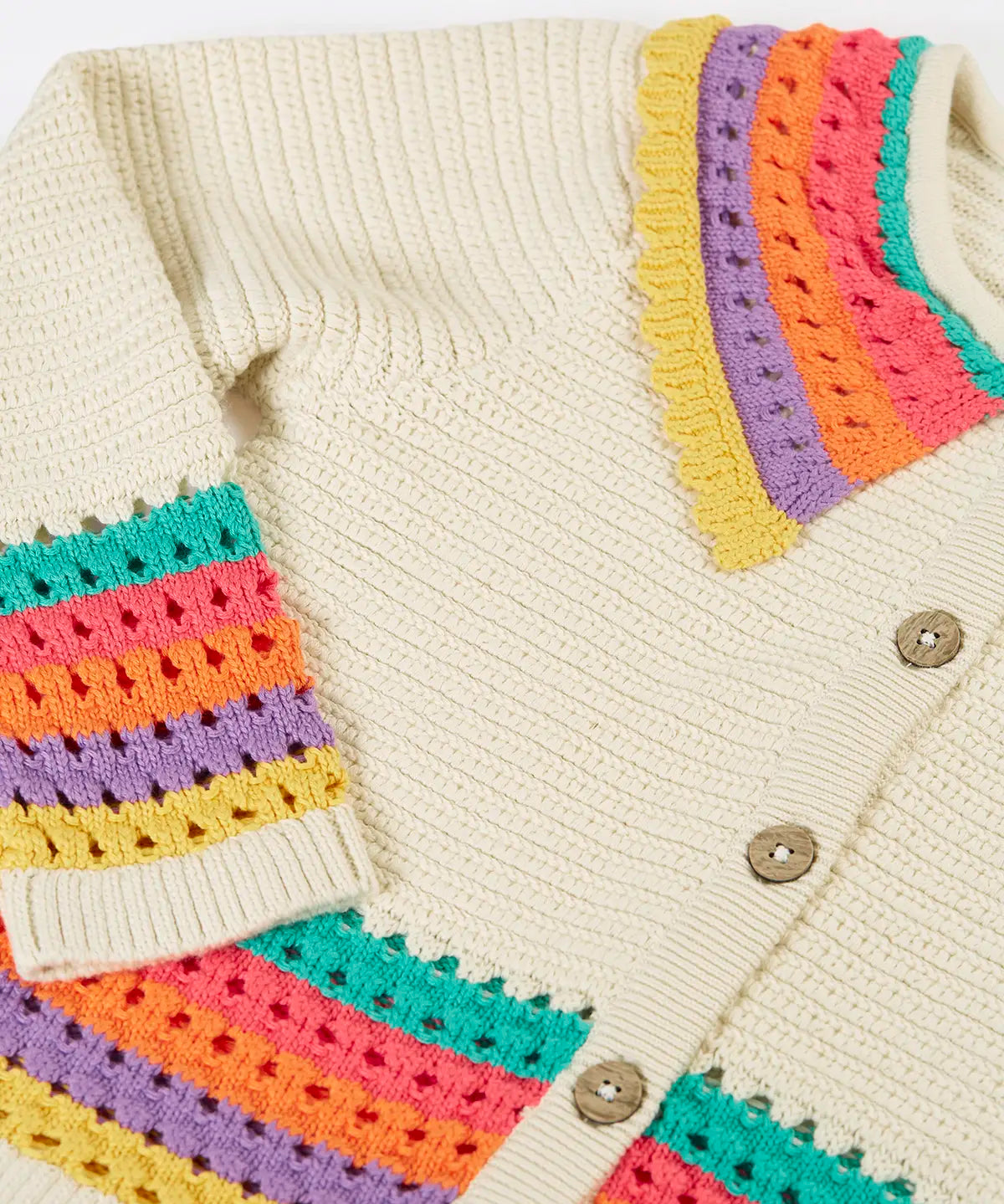 Frugi aurora collar cardigan in natural cream with rainbow stripe detail on bottom, cuffs and collar.