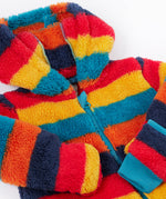 A close up o the Frugi kids recycled cosy snuggle suit in autumn stripe showing the blue zip detail and matching blue cuff on thick warm recycled textile fabric.