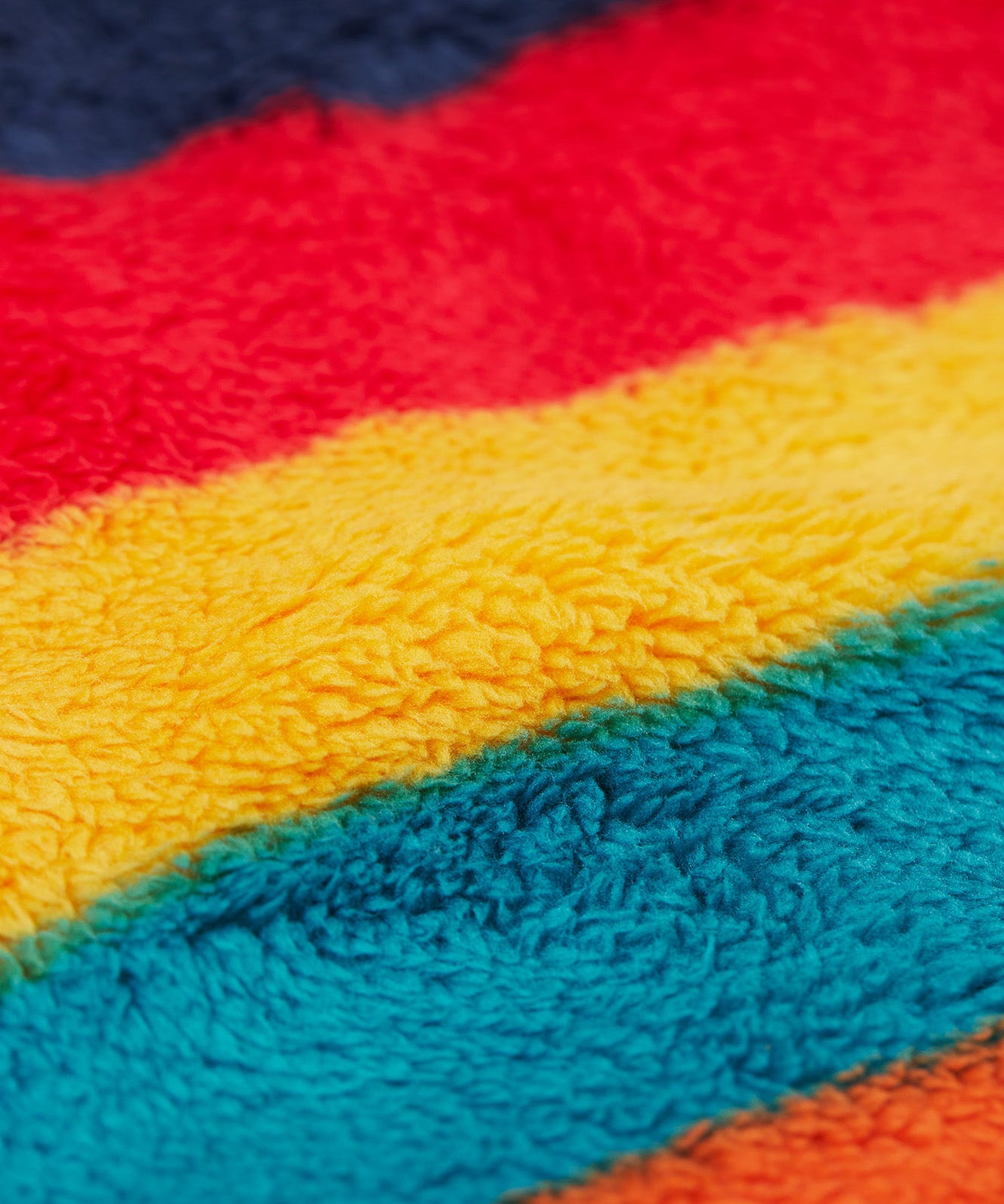 A close up of thick fleece detail on the Frugi Autumn stripe ted stripe fleece 