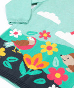 A close up of the design on the Frugi ava blue marl rainbow knitted children's dress.