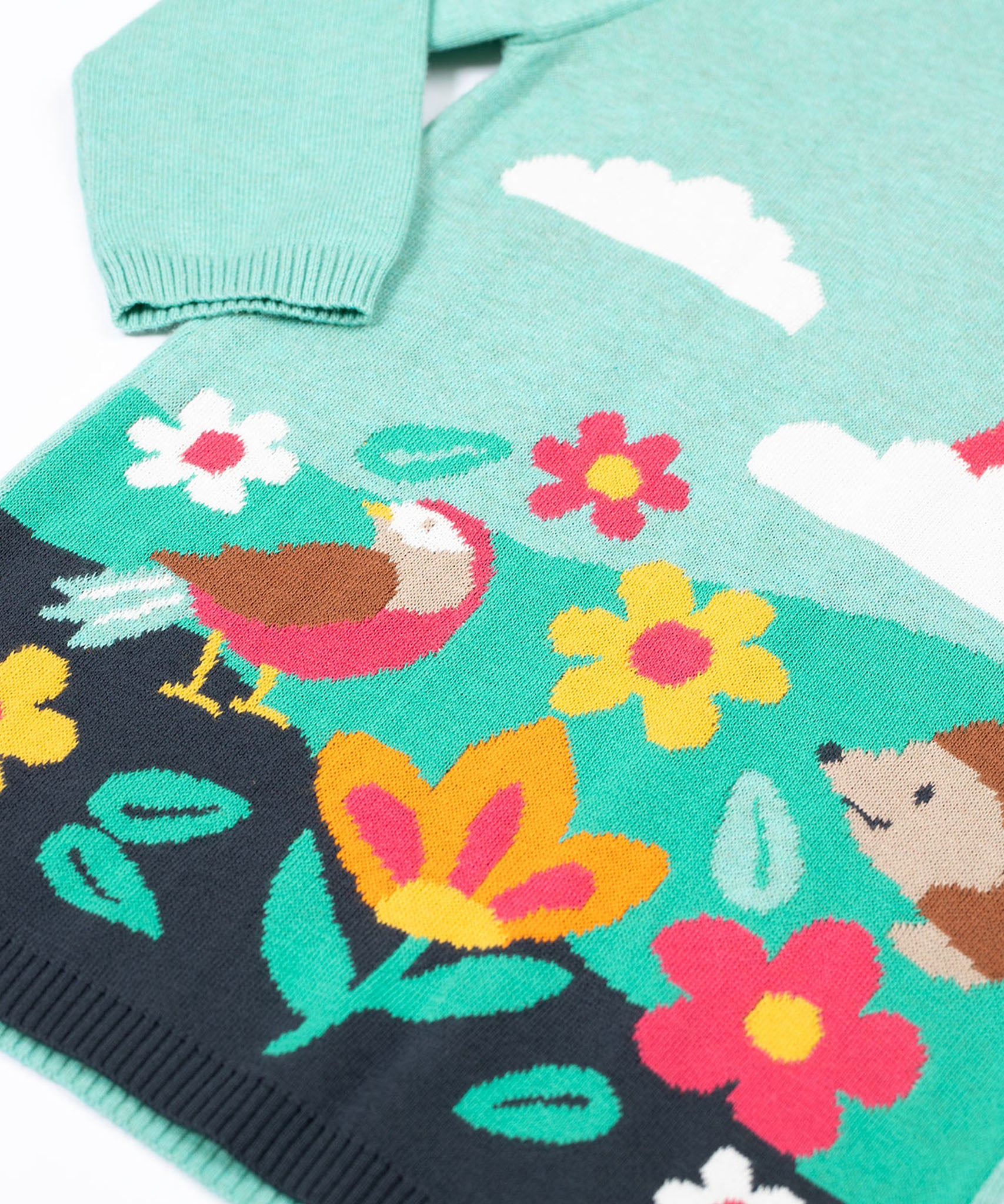 A close up of the design on the Frugi ava blue marl rainbow knitted children's dress.