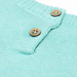 A close up of the button closure on the Frugi ava blue marl rainbow knitted children's dress.